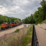 A train moving along the tracks parallel to the Galena River Trail.