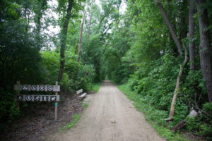 A scenic rest area with a bench and signs along the Galena River Trail near Casper Bluff.